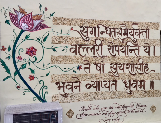 Hand-calligraphed Sanskrit verse with English translation, wall mural at Dak Bhawan