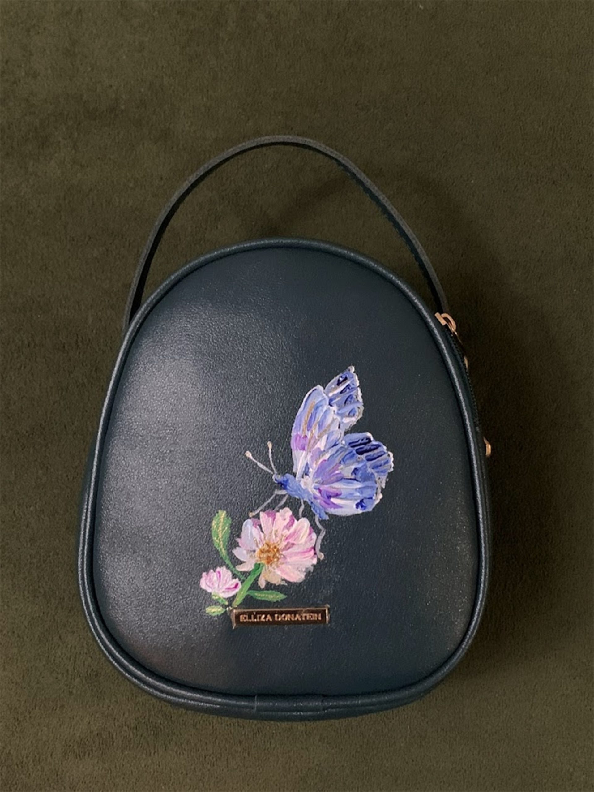 Hand-painted calligraphy accessory bag by Likhawat